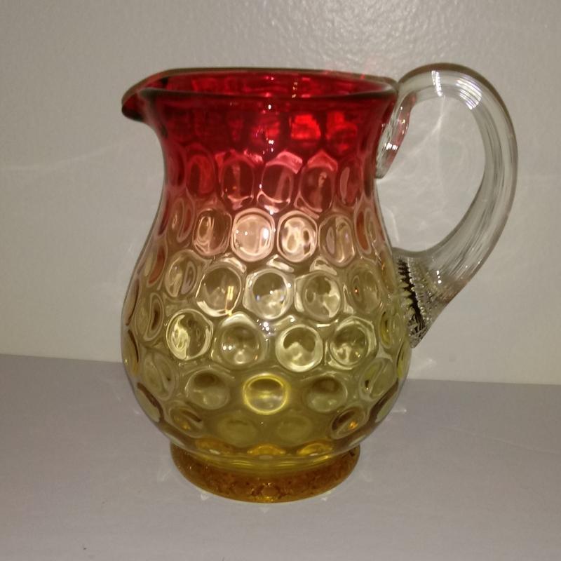 Amberina Coinspot Cream Pitcher with an applied reeded handle. 4 5/8 inches high.