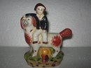 Porcelain Man riding Dog