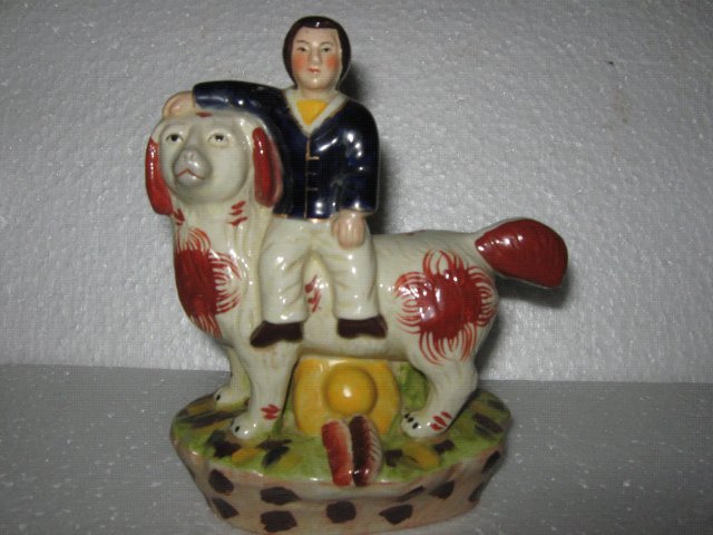 Porcelain Man riding Dog