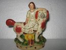 Porcelain Man riding Dog