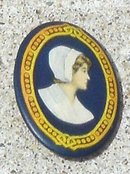 CELLULOID PINBACK OF WOMAN-WALTER BAKER COCOA WOMAN?