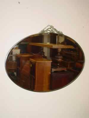 Beveled Oval Mirror with Floral & Leaf Chrome Crest