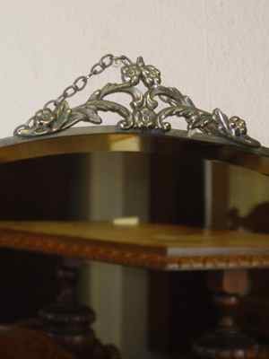 Beveled Oval Mirror with Floral & Leaf Chrome Crest