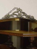 Beveled Oval Mirror with Floral & Leaf Chrome Crest