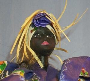 Ethnographic Doll In Purple Dress .
