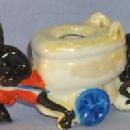 Black Memorabilia, Two Black Boys Pulling & Pushing A Toilet On Wheels Porcelain Figurine.