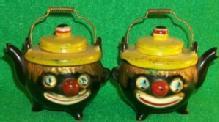 Salt & Pepper Shakers Shaped Like A Tea Pot With Clown Faces.