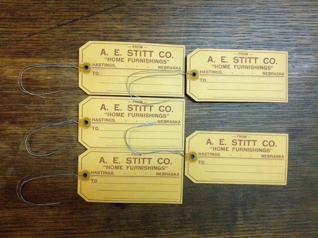 A E STITT COMPANY HOME FURNISHINGS CARDBOARD TAG HASTINGS NEBRASKA BUSINESS ADVERTISING TICKET DENISON IOWA USA MADE LABEL