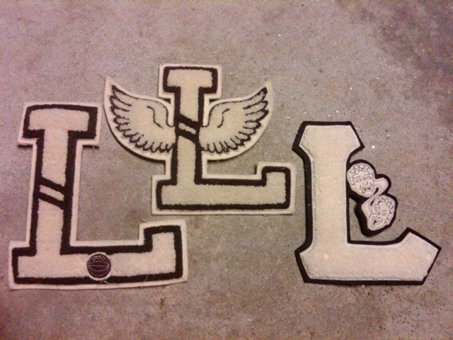 VARSITY LETTER L HIGH SCHOOL JACKET GARMENT APPAREL PATCH THEATRE BASKETBALL TRACK FIELD WINGS LOWE CAMPBELL ATHLETIC GOODS STICKER TAG