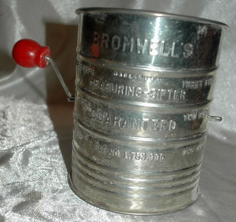 Bromwell’s tin flour sifter with a red painted wooden sifter handle
