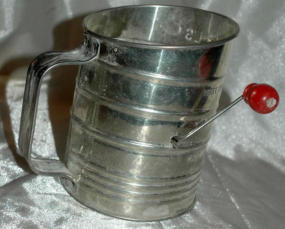 Bromwell’s tin flour sifter with a red painted wooden sifter handle
