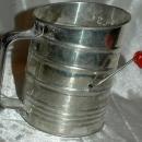Bromwell’s tin flour sifter with a red painted wooden sifter handle
