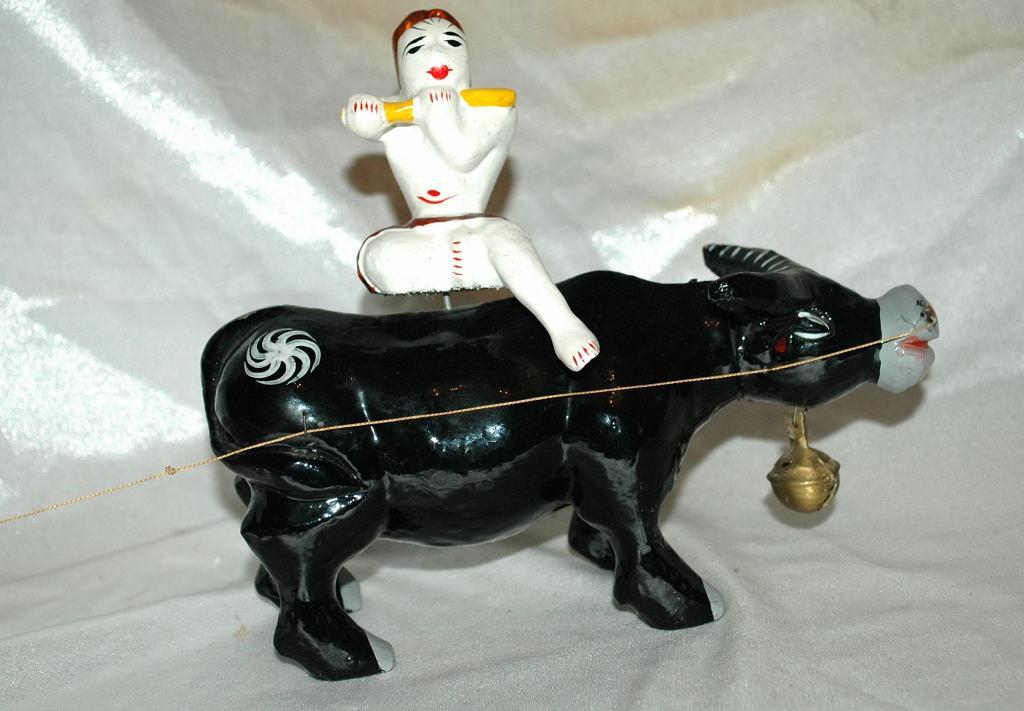 Asian Folk Art Wooden Bull with Articulated Head and Flute Player Rider.