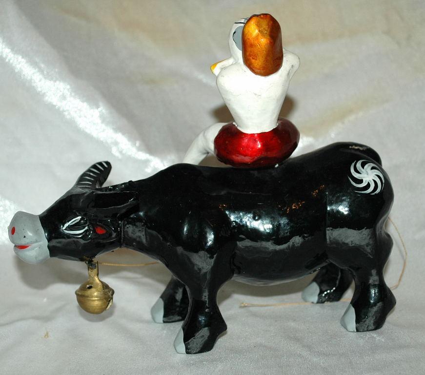Asian Folk Art Wooden Bull with Articulated Head and Flute Player Rider.