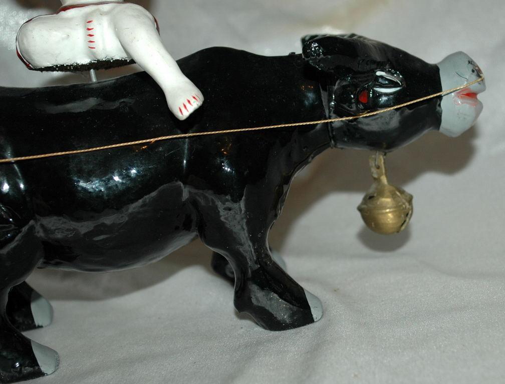 Asian Folk Art Wooden Bull with Articulated Head and Flute Player Rider.