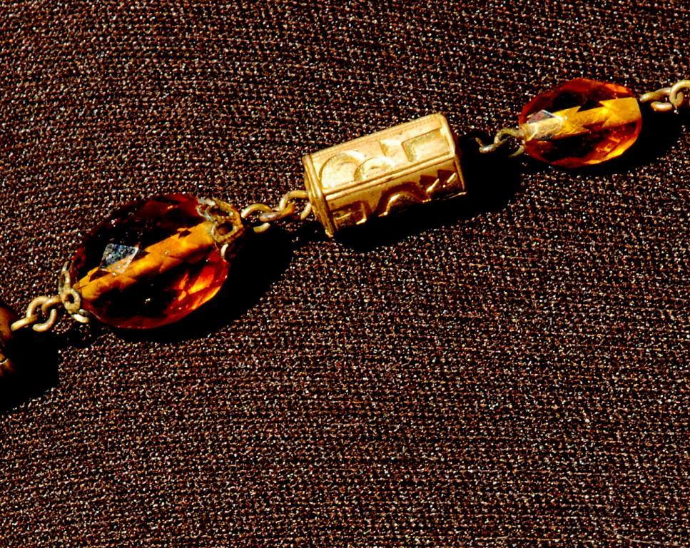 Faceted Amber Glass and Engraved Brass Necklace. Very Old