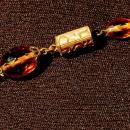 Faceted Amber Glass and Engraved Brass Necklace. Very Old