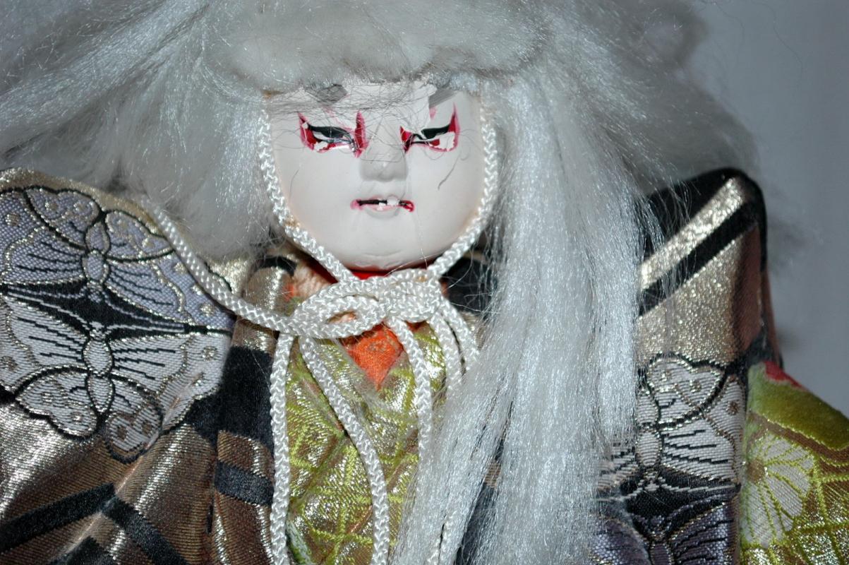 Doll of Kabuki Theatre actor as White Lion with one knee raised