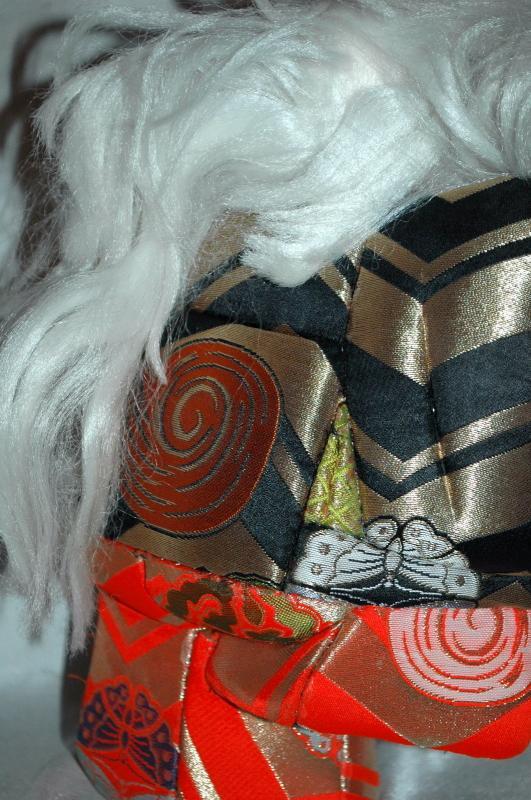 Doll of Kabuki Theatre actor as White Lion with one knee raised