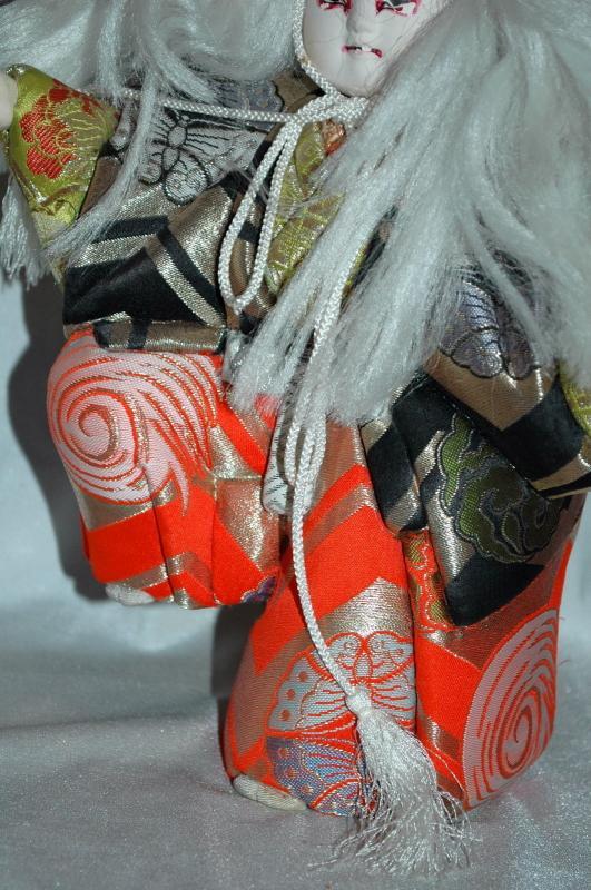 Doll of Kabuki Theatre actor as White Lion with one knee raised